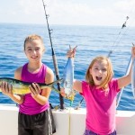 girls catching their first fish on a fishing charter