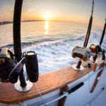 boat fishing rods over a beautiful cloudy seascape